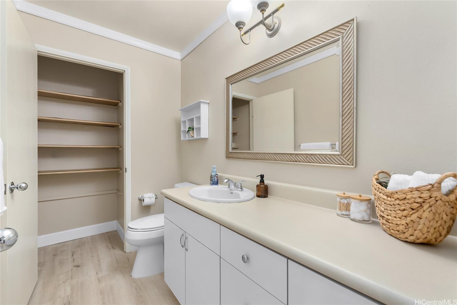 4562 Malia Street Honolulu, HI 96821 - Photo 17 of 25 a en suite bathroom with a double vanity sink and a mirror