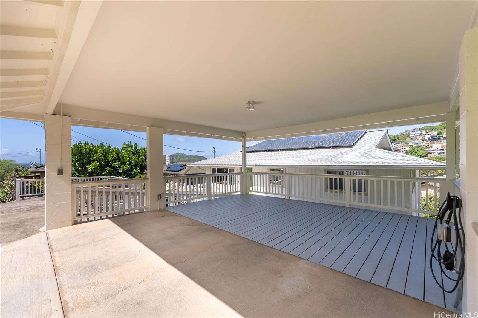 4562 Malia Street Honolulu, HI 96821 - Photo 22 of 25 a view of a house with wooden deck and a backyard