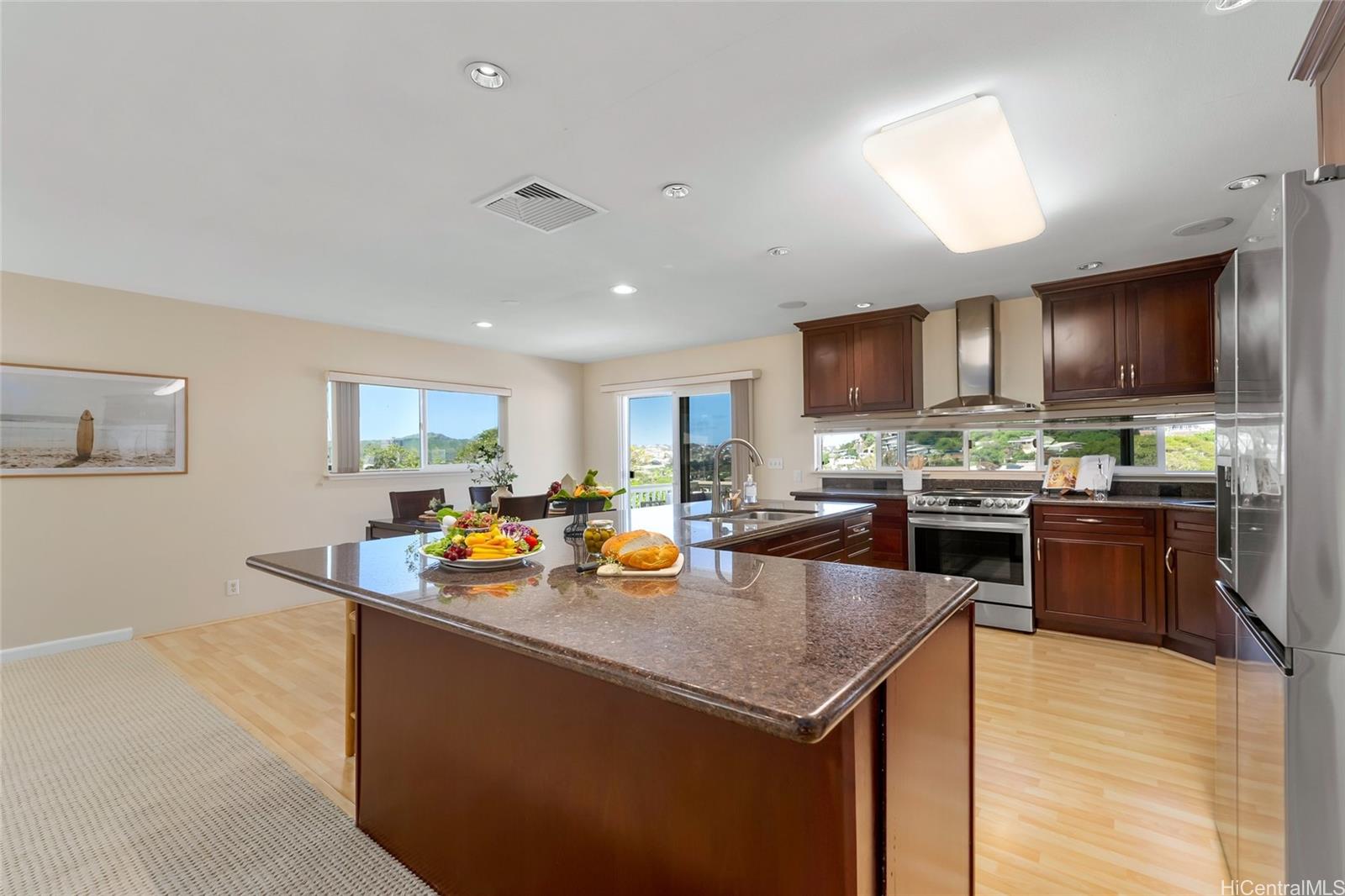 4562 Malia Street Honolulu, HI 96821 - Photo 7 of 25 a kitchen with stainless steel appliances granite countertop a sink a stove and a refrigerator
