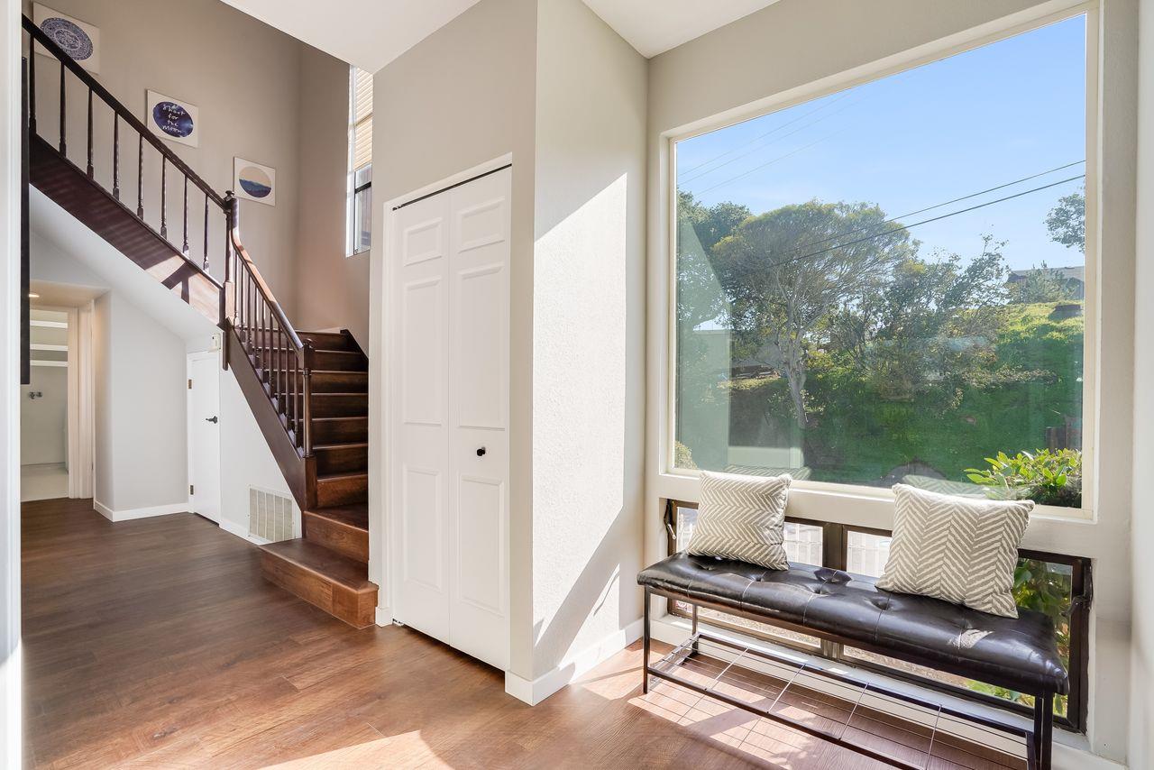 1176 Millbrae Avenue Millbrae, CA 94030 - Photo 22 of 47 a view of a hallway with wooden floor and stairs