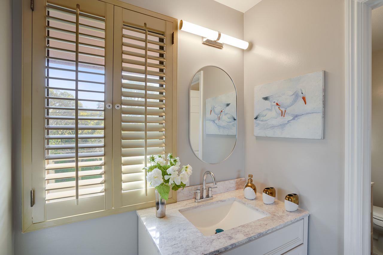 1176 Millbrae Avenue Millbrae, CA 94030 - Photo 35 of 47 a bathroom with a granite countertop sink a large mirror and a window