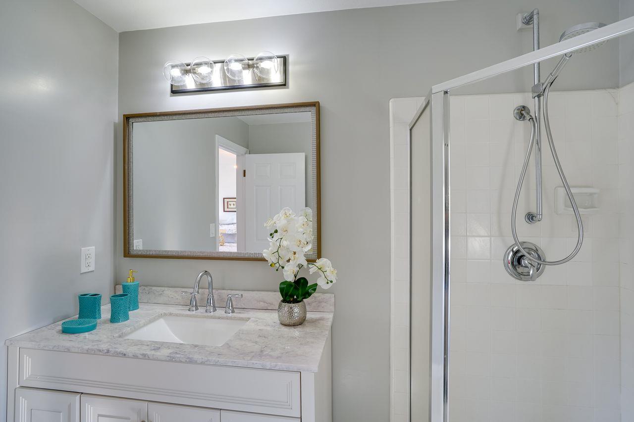 1176 Millbrae Avenue Millbrae, CA 94030 - Photo 40 of 47 a bathroom with a granite countertop sink a mirror and a shower