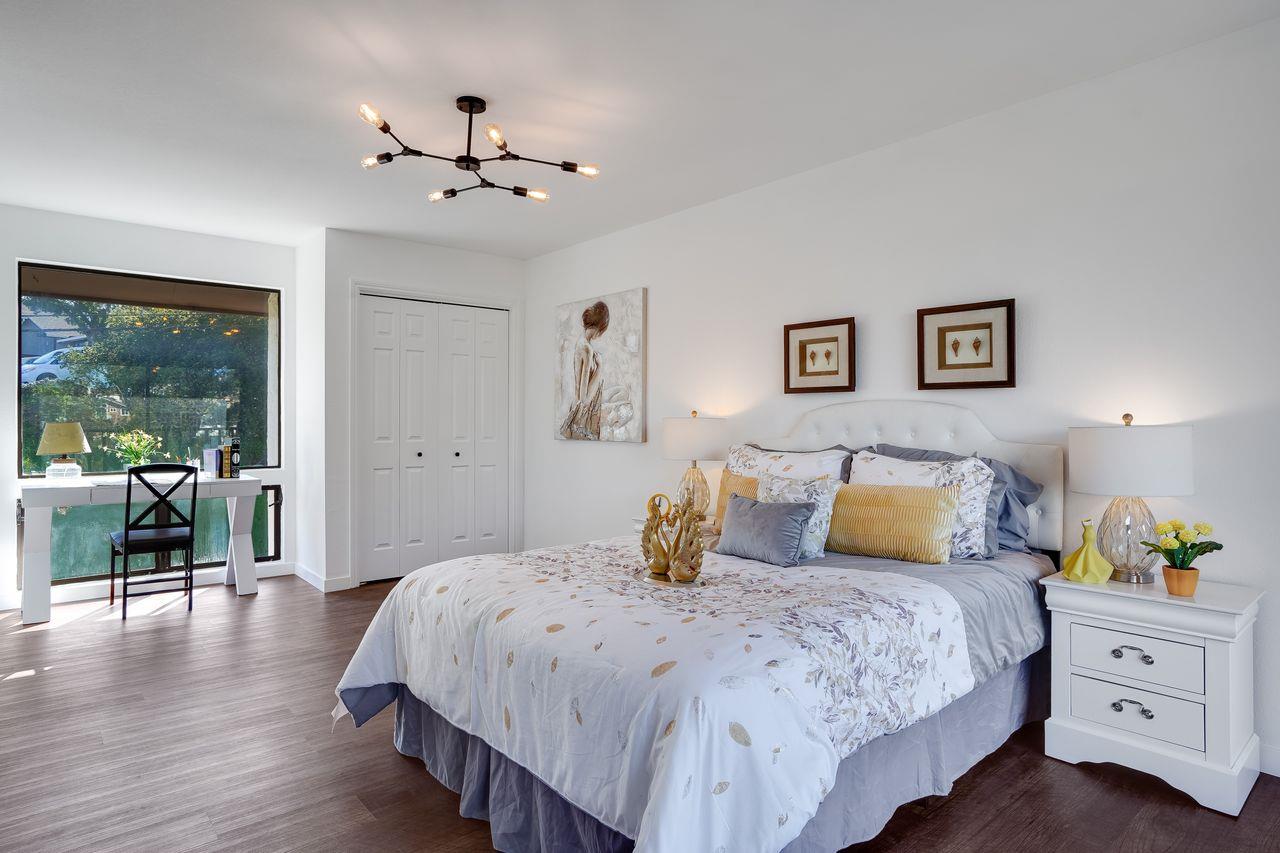 1176 Millbrae Avenue Millbrae, CA 94030 - Photo 41 of 47 a bedroom with a large bed and a chandelier