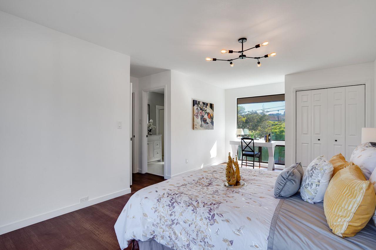 1176 Millbrae Avenue Millbrae, CA 94030 - Photo 42 of 47 a bedroom with a large bed and a chandelier