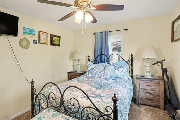 a bedroom with a bed and a flat tv screen