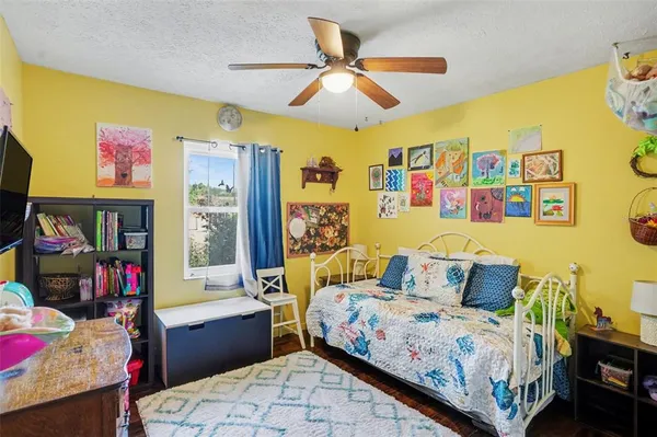 a bedroom with a bed and flat screen tv