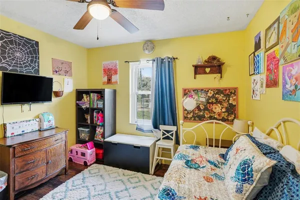a bedroom with furniture a baby crib and a chandelier