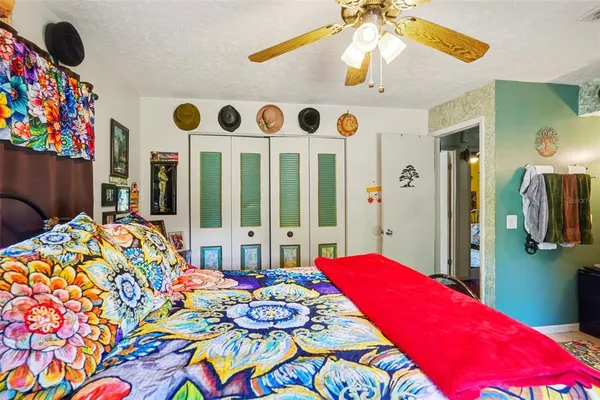 a bedroom with a bed furniture and a flat tv screen