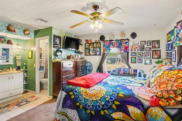 a bedroom with a bed and a book shelf