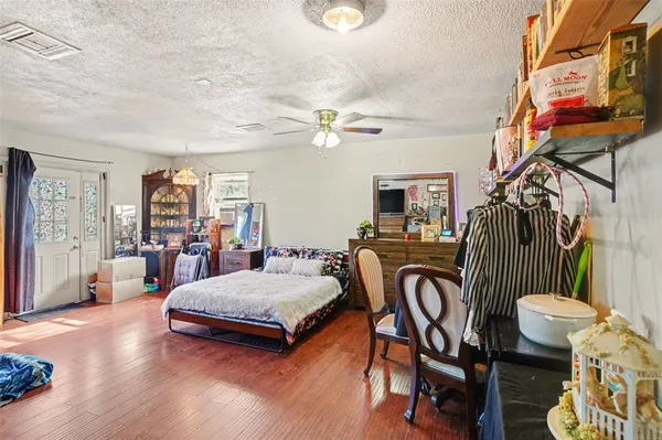 a living room with patio furniture and a flat screen tv