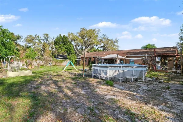 a view of house with backyard porch and sitting area