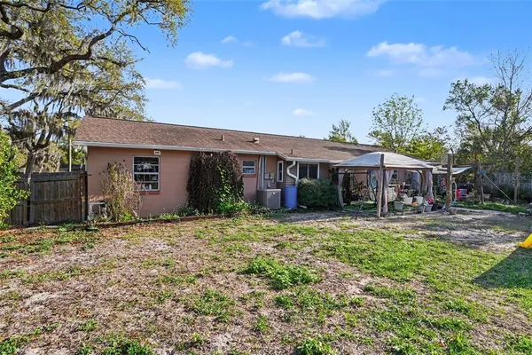 a view of a garden with a house in the background