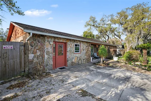 a view of a house with backyard and sitting area