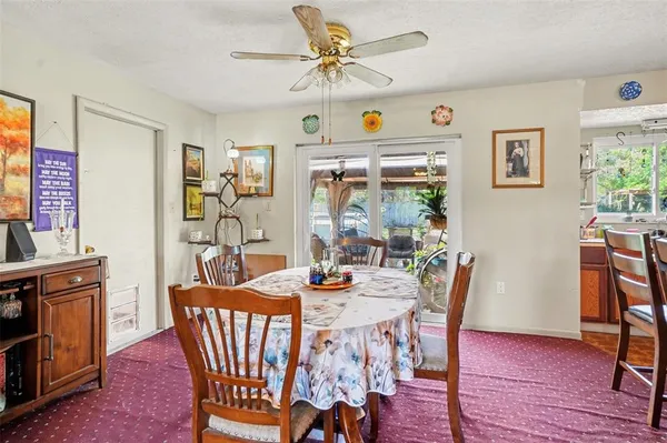 a dining room with furniture a window and wooden floor