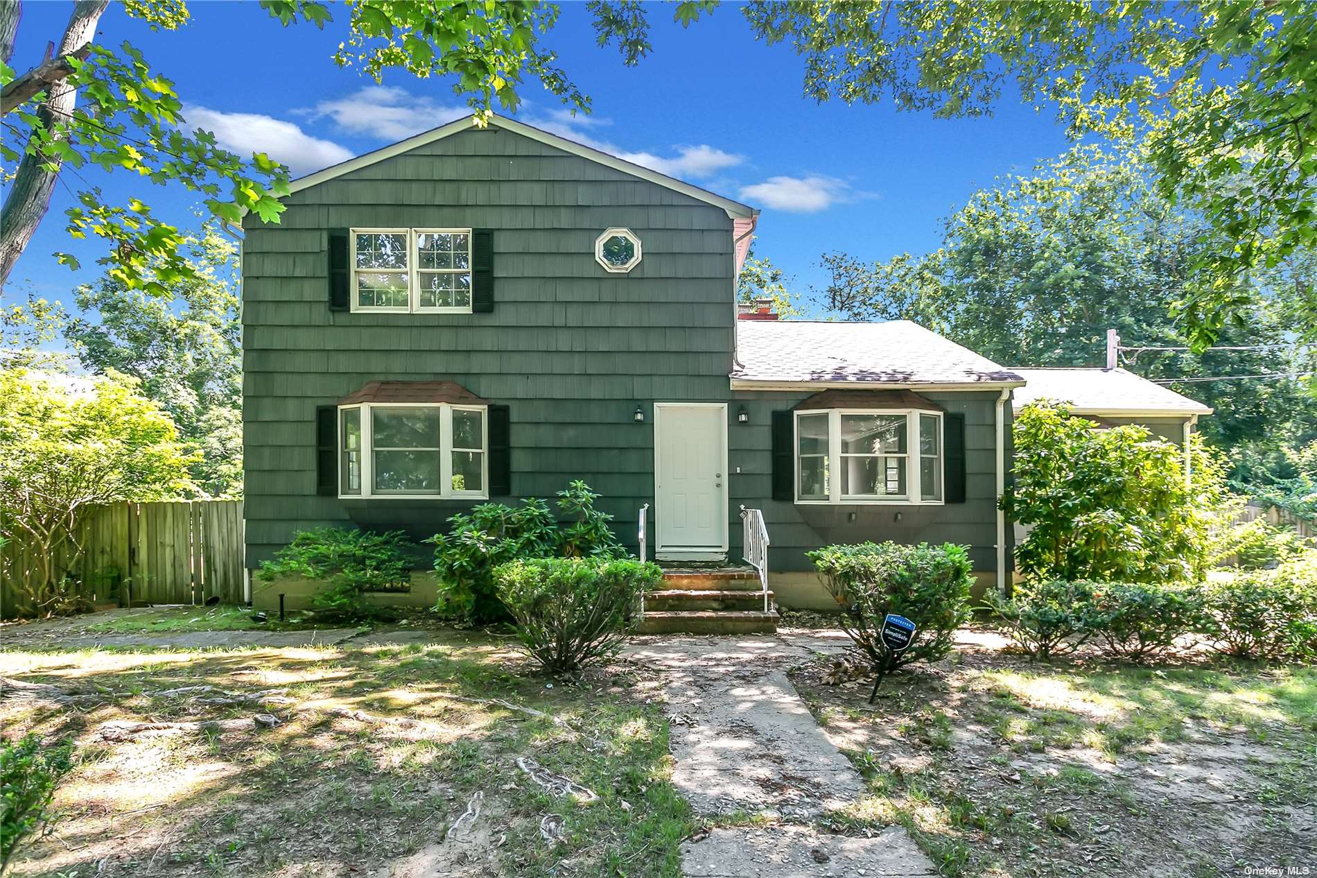 9 Half Moon Pond Road Ridge, NY 11961 - Photo 1 of 1 a front view of a house with a yard