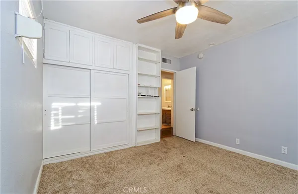 a view of an empty room with a ceiling fan
