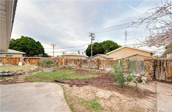 a view of a house with a yard and sitting area
