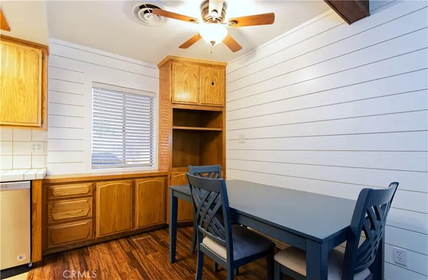 a view of a workspace with furniture and window