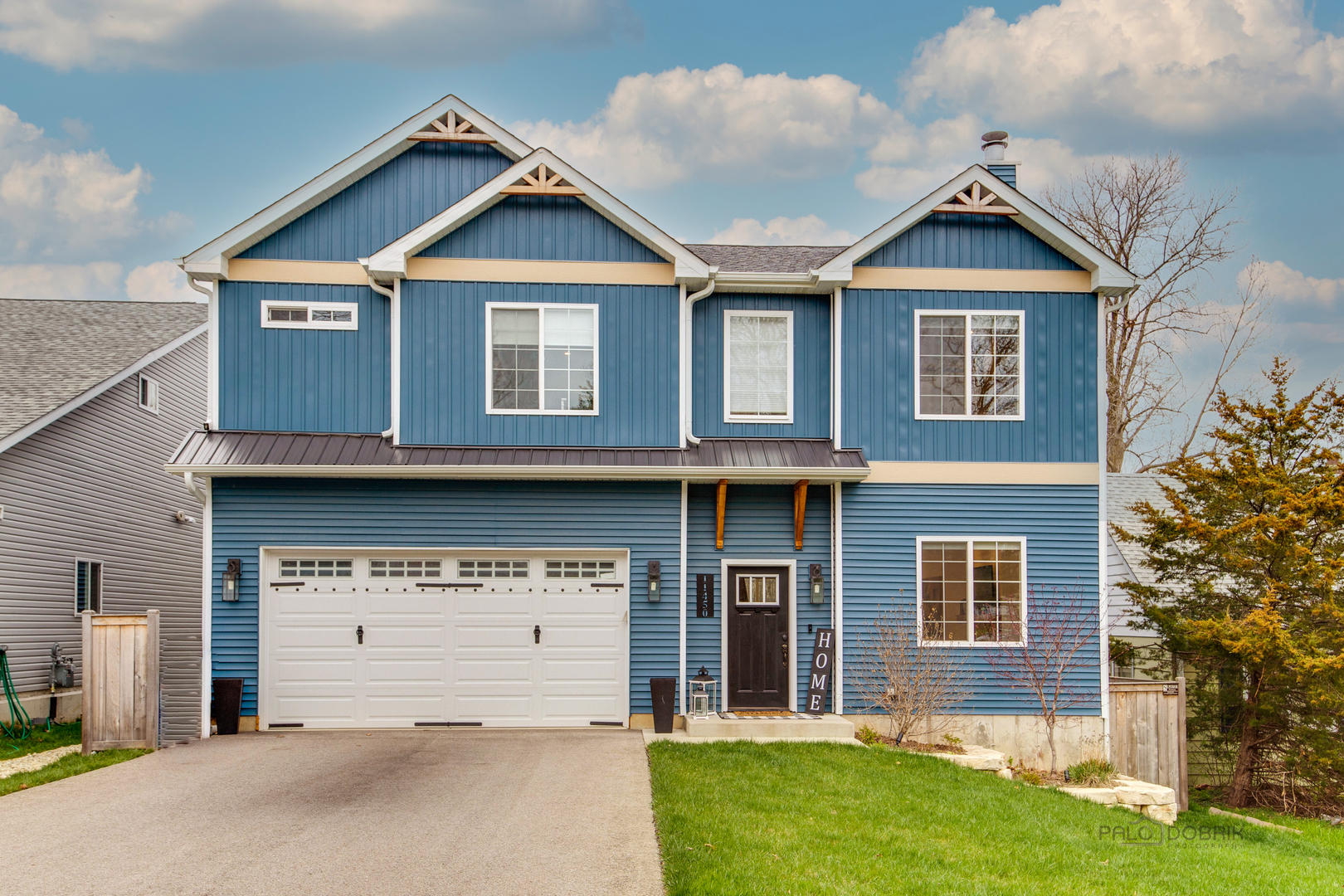 a front view of a house with a yard and garage