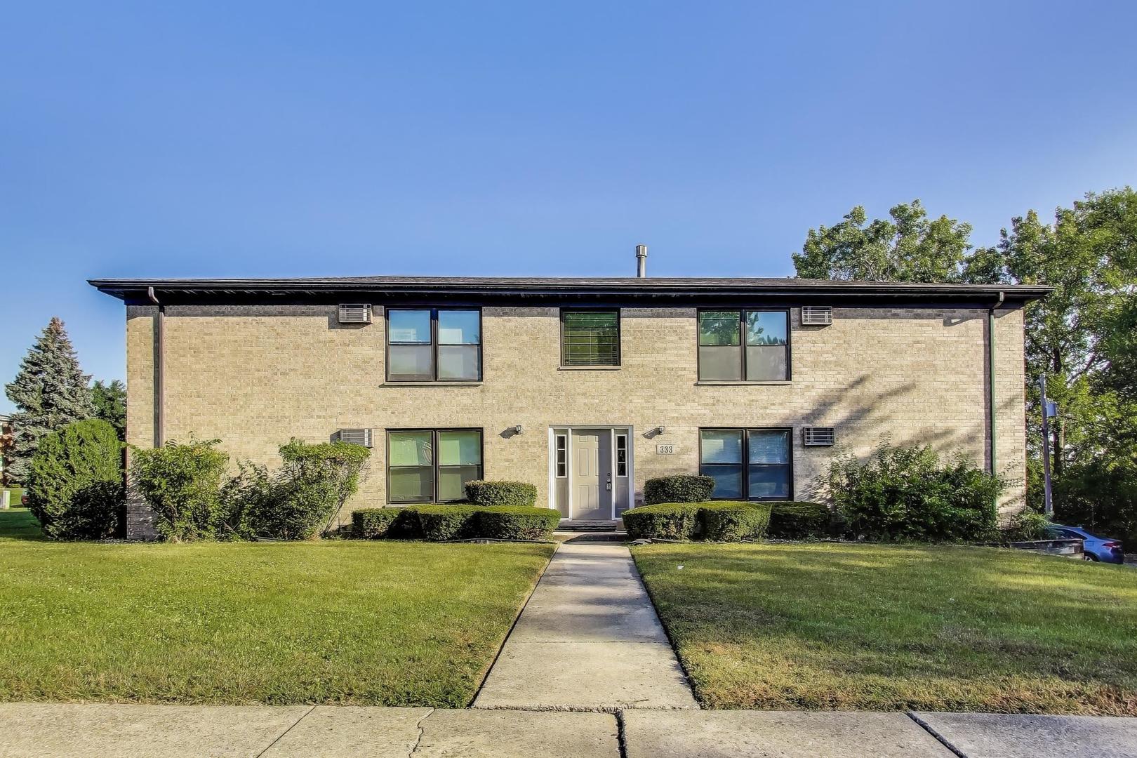 333 Short Street, Unit 2 Lemont, IL 60439 - Photo 1 of 11 a front view of a house with a yard