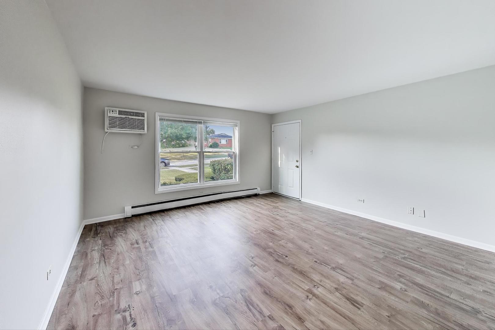 333 Short Street, Unit 2 Lemont, IL 60439 - Photo 4 of 11 an empty room with wooden floor and window