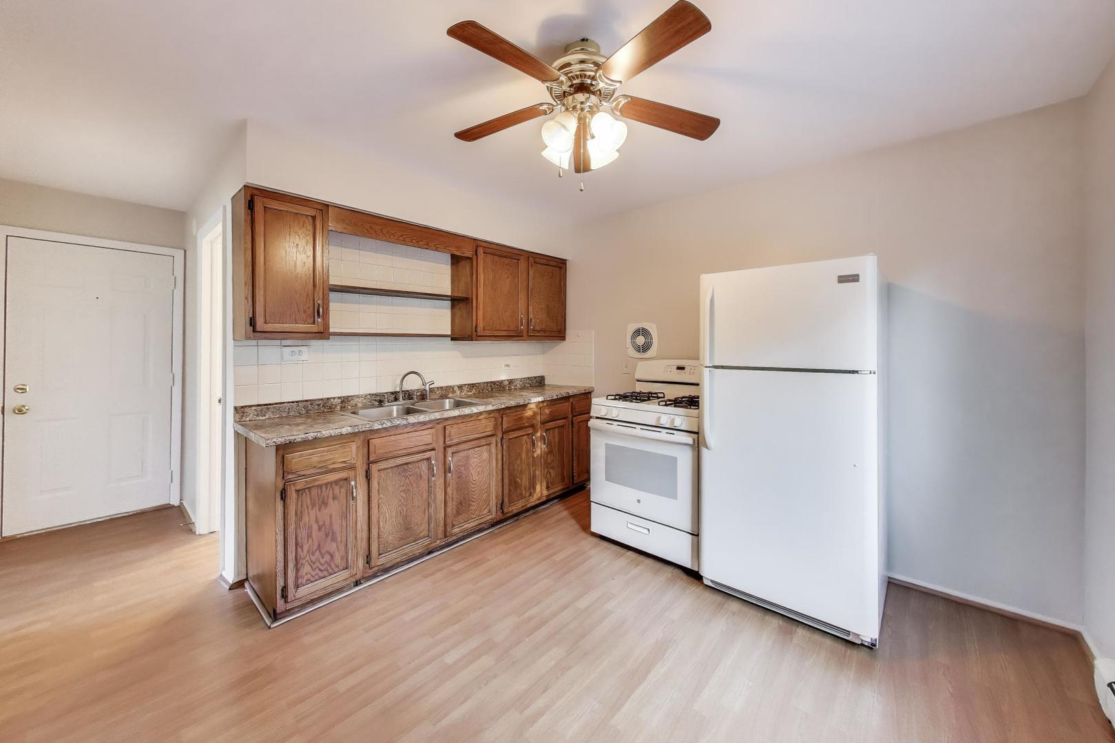 333 Short Street, Unit 2 Lemont, IL 60439 - Photo 6 of 11 a kitchen with white cabinets and white appliances