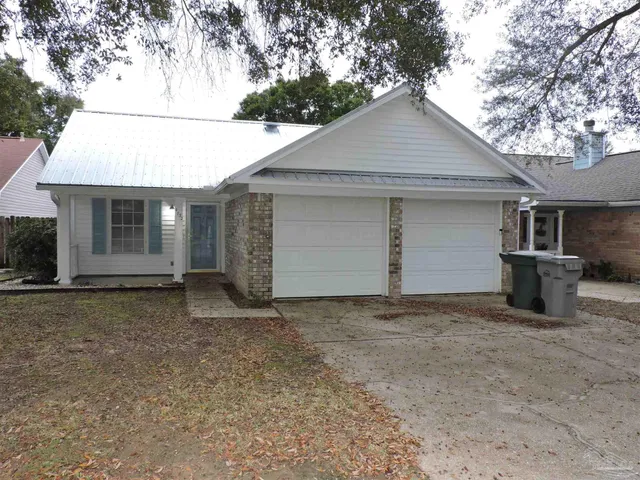 a view of a house with a wooden fence