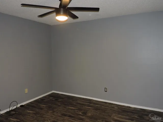 an empty room with wooden floor and closet