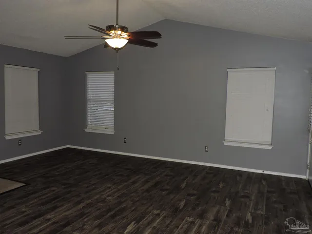 a kitchen with granite countertop a sink a stove and cabinets