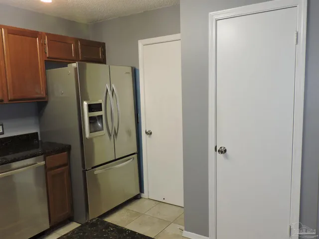 a kitchen with a refrigerator and a sink