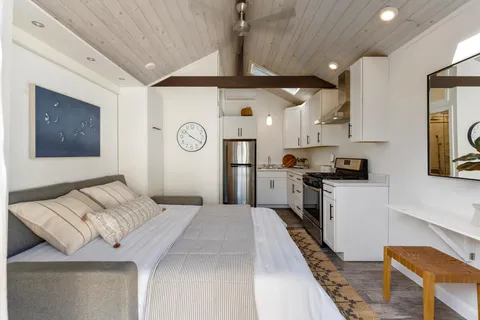 a kitchen with cabinets and wooden floor