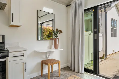 a view of hallway with cabinets and a potted plant