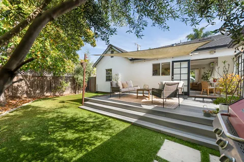 a view of a house with backyard porch and sitting area
