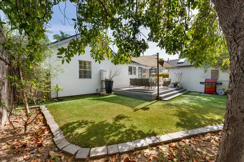 a view of a house with swimming pool and a yard