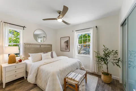 a bedroom with a bed and a chandelier
