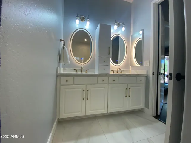a bathroom with a mirror and sink