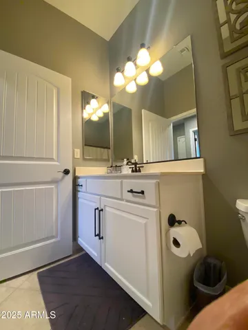a bathroom with a sink a toilet and mirror