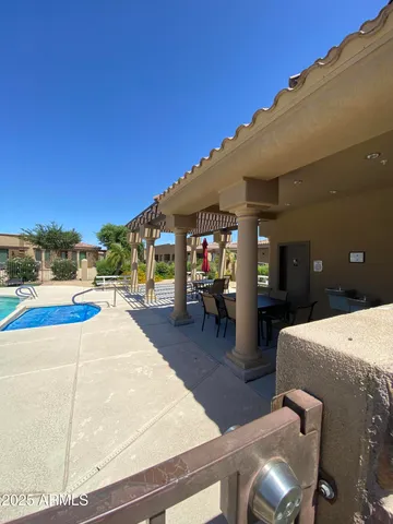 a view of a patio with table and chairs
