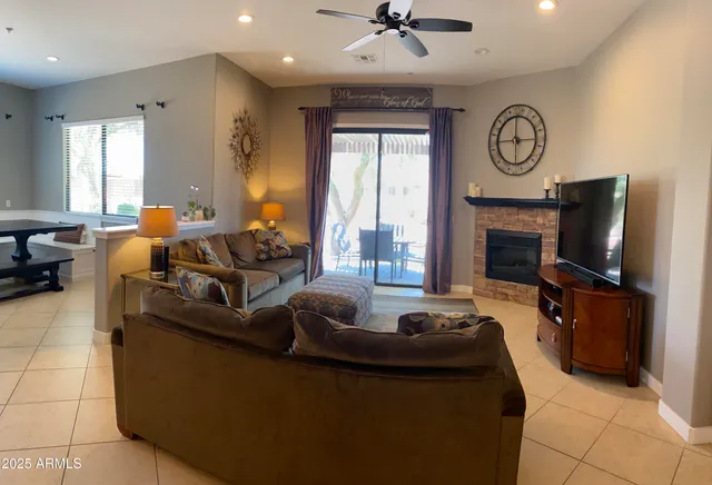 a living room with furniture a fireplace and a flat screen tv