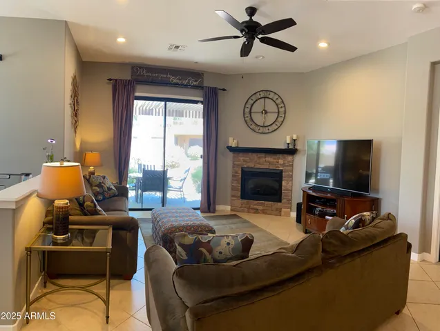 a living room with furniture a clock and a fireplace