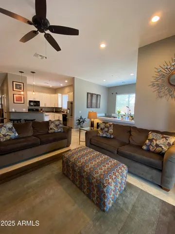 a living room with furniture ceiling fan and a rug
