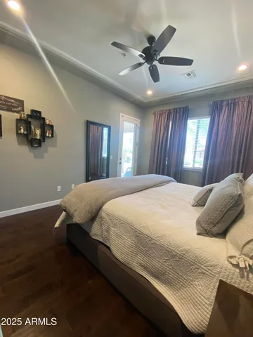 a bedroom with a bed and a ceiling fan