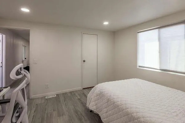 a bedroom with a bed and a window