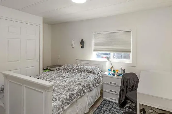 a bedroom with a bed and a window
