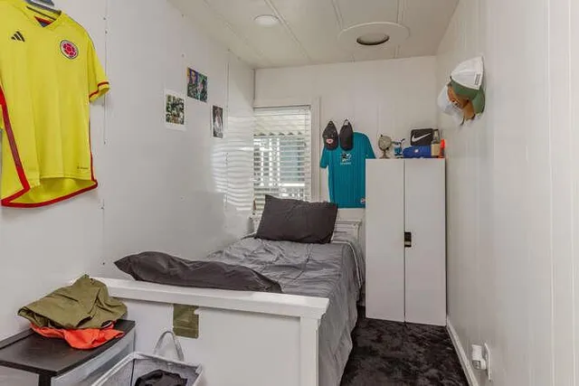 a bedroom with a bed and a window