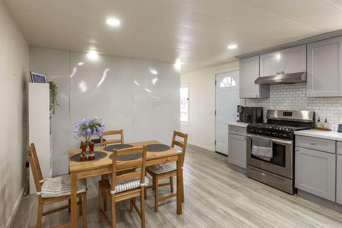 2151 Oakland Road, Unit 297 San Jose, CA 95131 - Photo 2 of 34 a kitchen with stainless steel appliances kitchen island granite countertop a stove a sink a refrigerator and a dining table