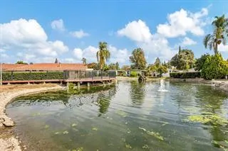 a view of a lake with houses in the background