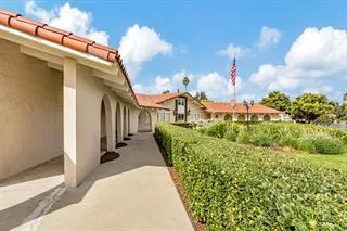 a view of a house with a big yard and potted plants