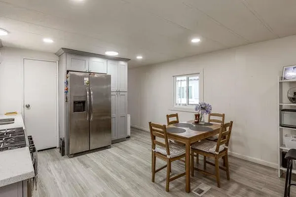 a kitchen with a table and refrigerator