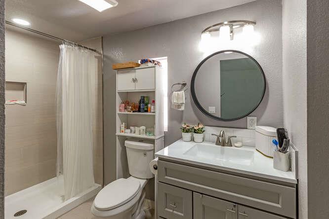 2151 Oakland Road, Unit 297 San Jose, CA 95131 - Photo 6 of 34 a bathroom with a sink a mirror a toilet and a shower
